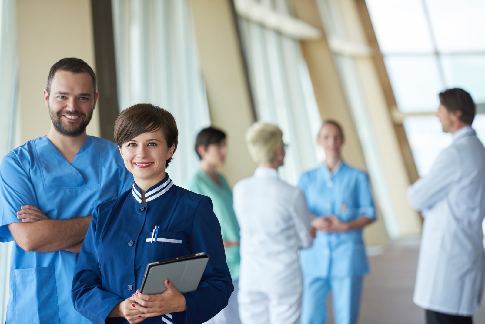 Healthcare staff boarding a shuttle bus outside a hospital entrance in Toronto