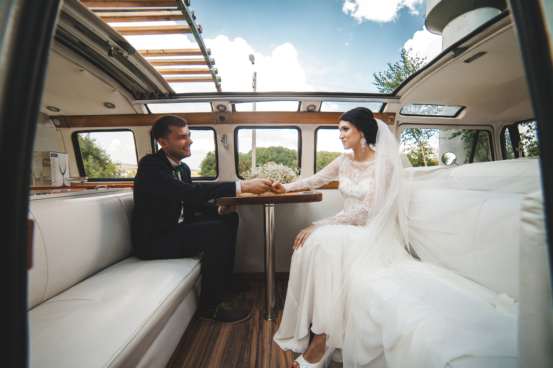 White wedding shuttle coach picking up guests outside a Toronto wedding venue